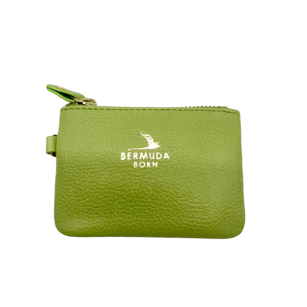 A small lime green pebbled leather zippered pouch with a gold zipper and a gold 'BERMUDA BORN' logo printed on the front, shown on a plain white background.
